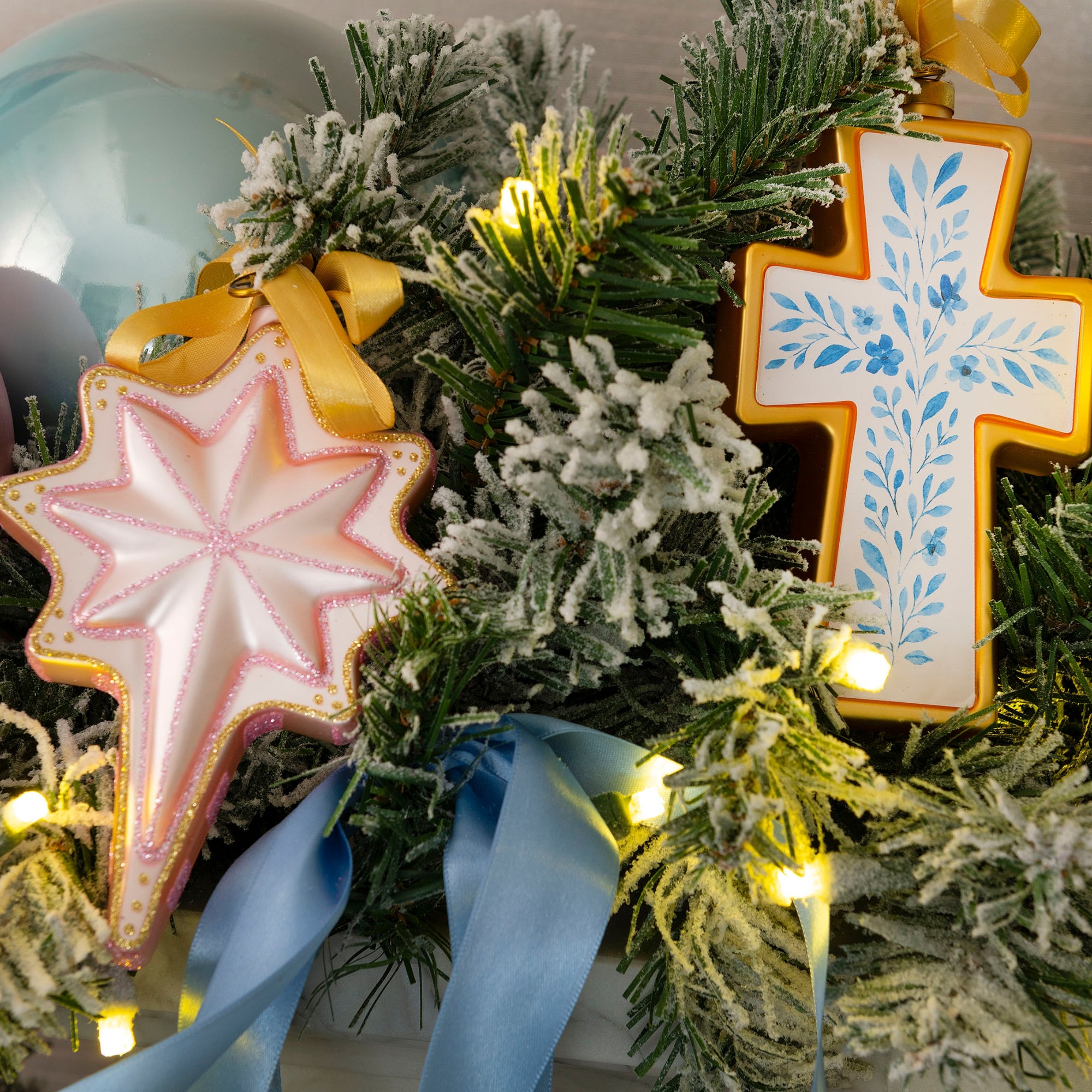 Nativity star and floral cross blown glass Christmas ornament